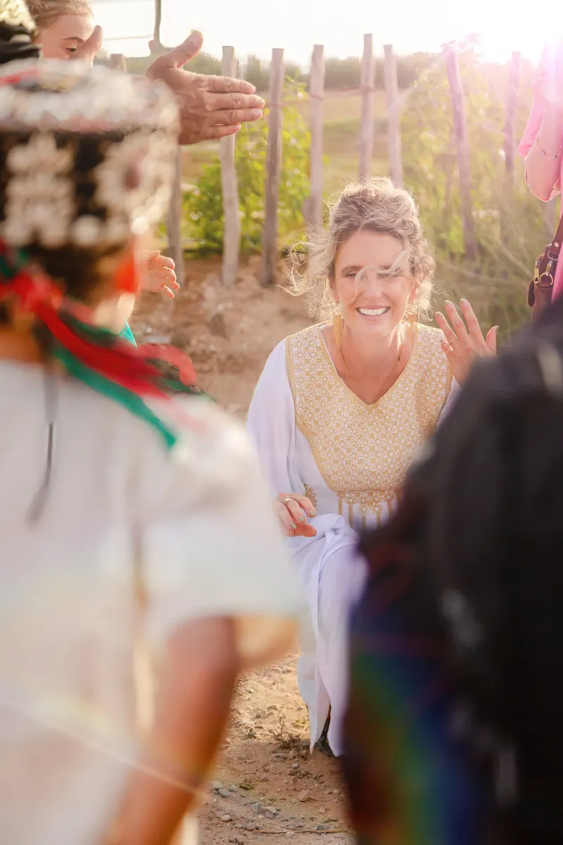 Bride laughing during the outdoor ceremony - Dragonzay Photography
