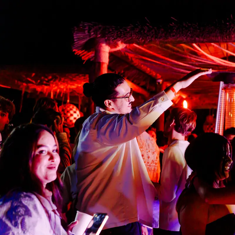 Party atmosphere under a red tent at a wedding - Dragonzay Photography
