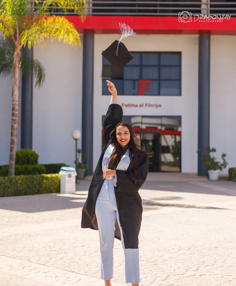 Graduate throwing her cap in front of the faculty - Dragonzay Photography