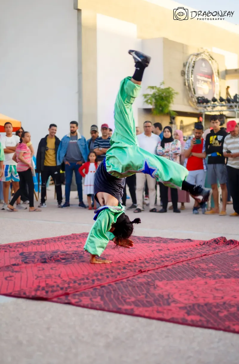 Breakdancer mid-move in front of the audience - Dragonzay Photography