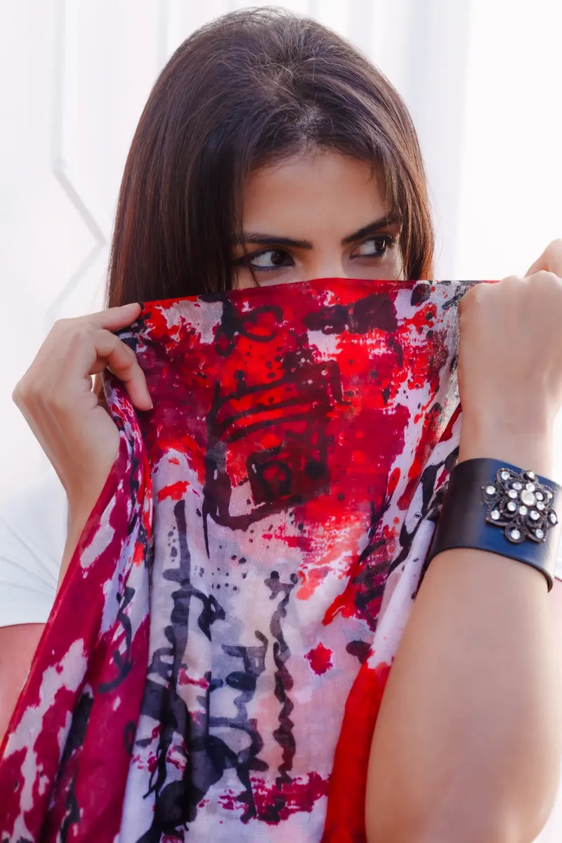 Model hiding her face behind a red printed scarf - Dragonzay Photography