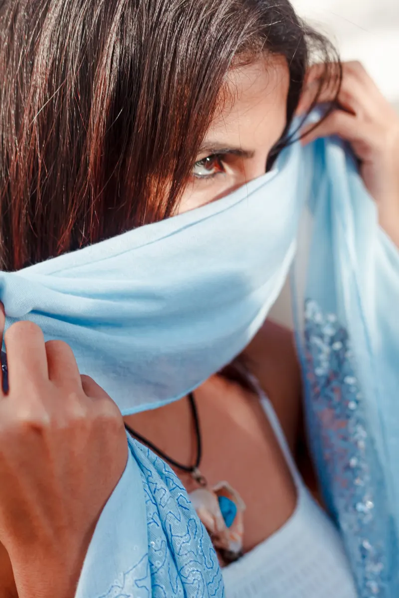 Model pulling a blue scarf across her face - Dragonzay Photography