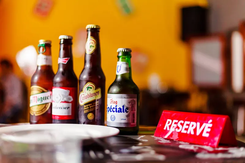 Casablanca and Spéciale beer bottles on a bar counter - Dragonzay Photography