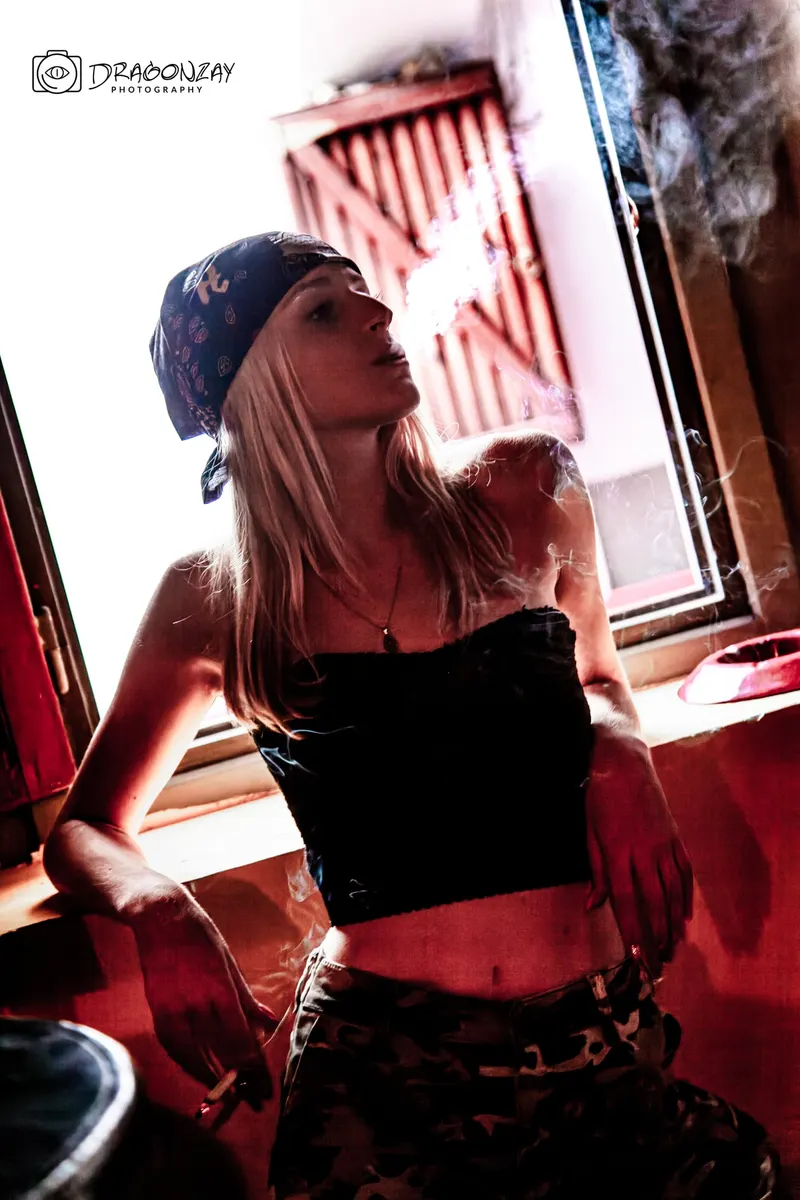 Portrait in a black hat with a drink in a lounge setting - Dragonzay Photography