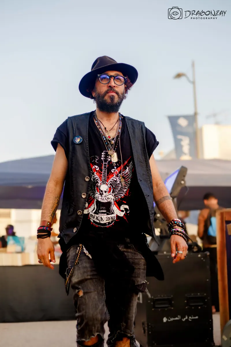 Man in a hat and sleeveless vest outdoors - Dragonzay Photography