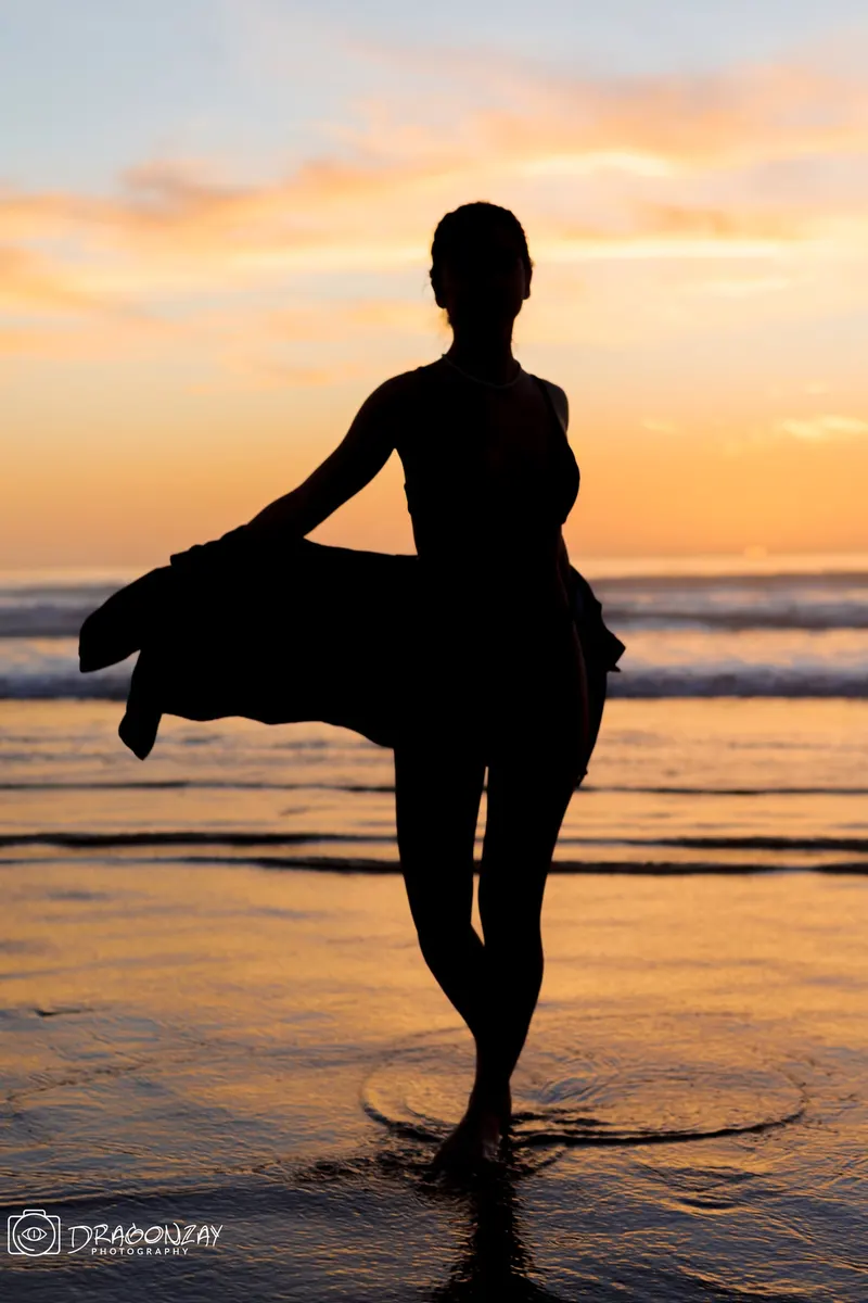 Silhouette of a dancer at sunset on the beach - Dragonzay Photography
