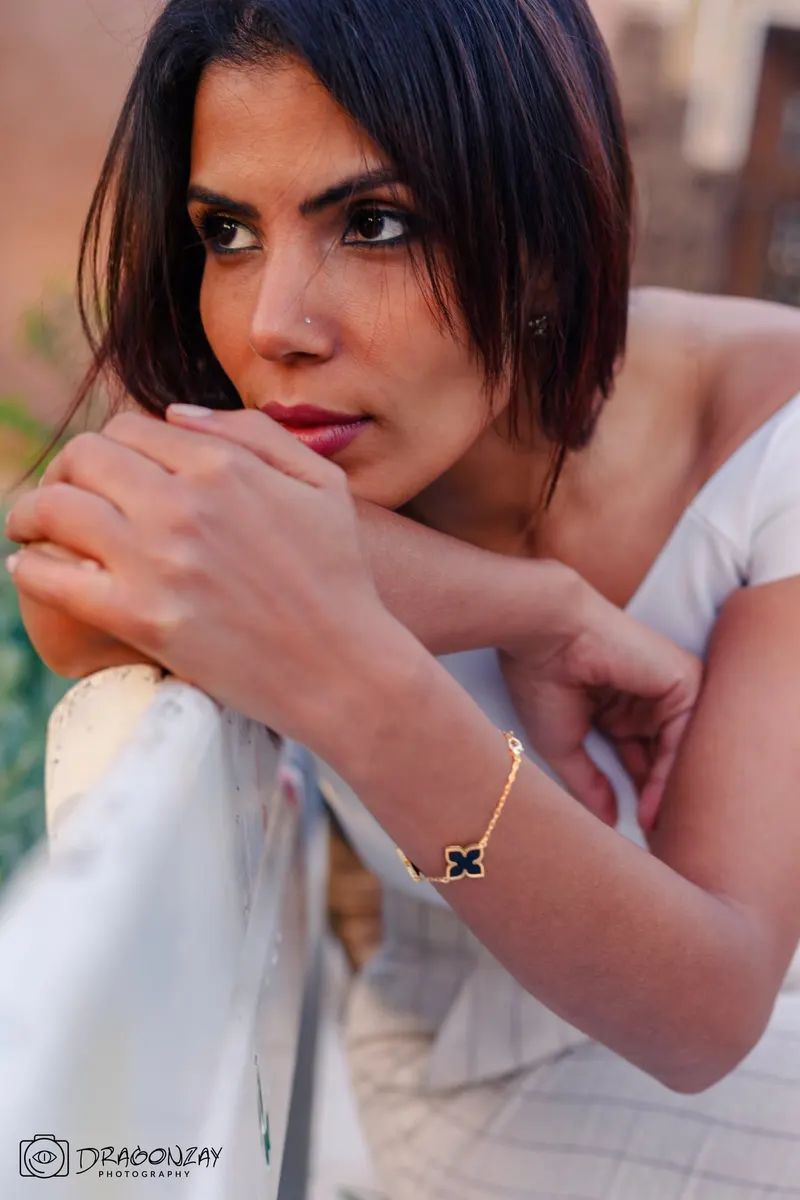 Beauty portrait of a woman in an orange top in a garden - Dragonzay Photography
