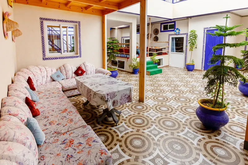 Dining room under a glass roof with cement tile floors - Dragonzay Photography