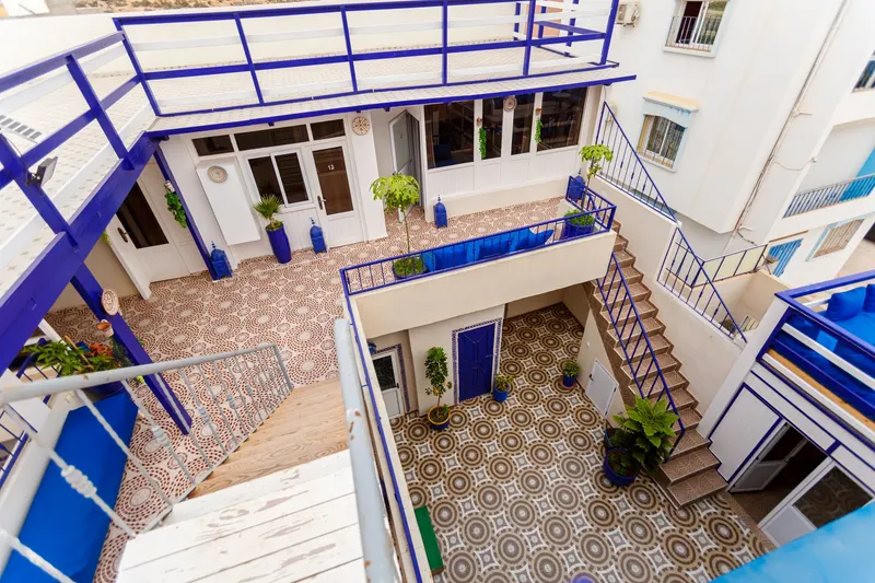 Patio and staircase of a blue and white riad seen from above - Dragonzay Photography