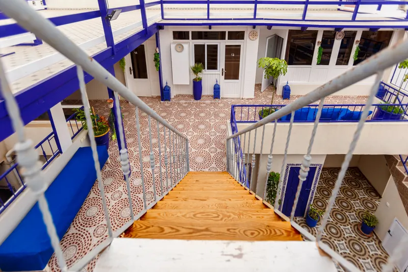 Patio and staircase of a blue and white riad seen from above - Dragonzay Photography